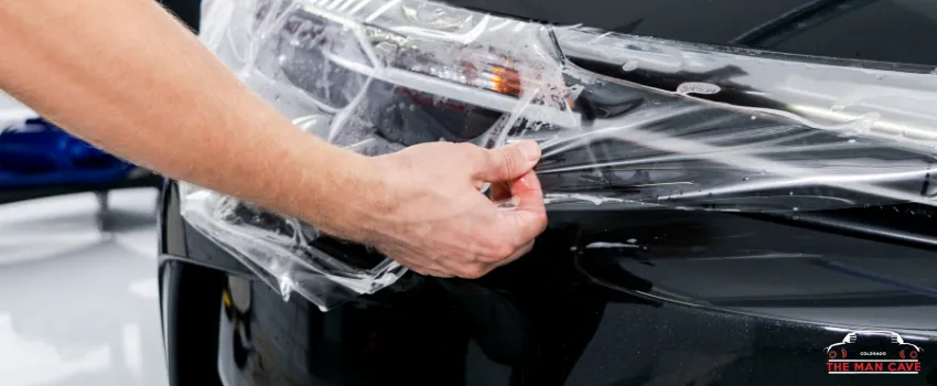 TMC - Mechanic applying paint protection film on a car